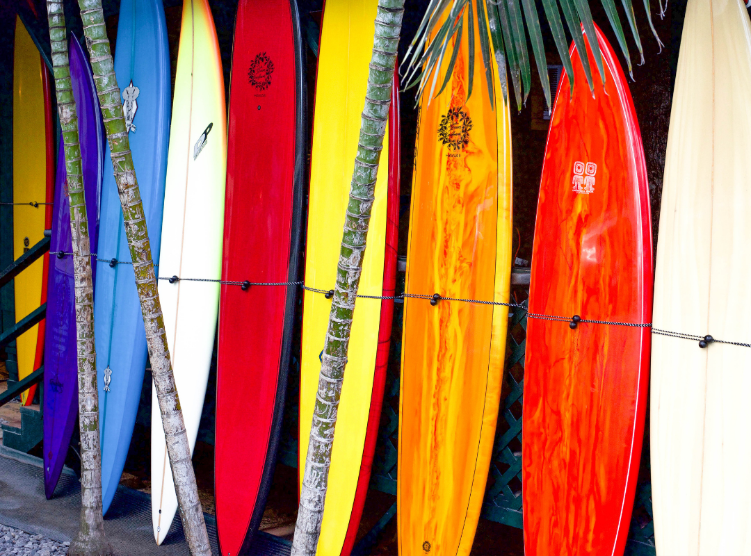 Surfboards stacked on the beach
